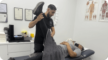 physiotherapist-treating-a-man-using-equipment-